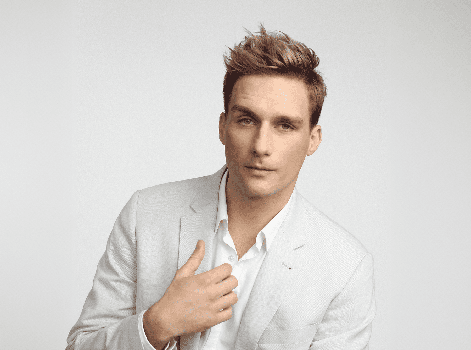 Short men’s haircut with a clean tapered shape and textured top