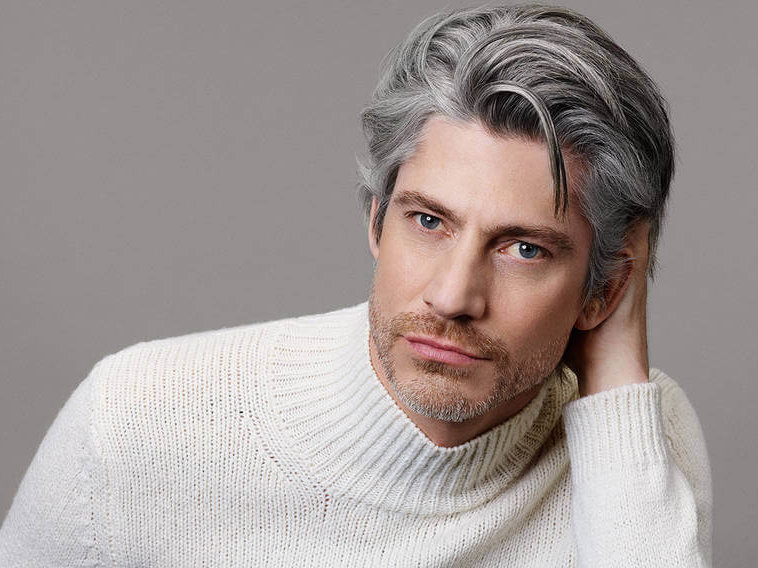 Man with naturally silver and darker hair showing a soft grey blend