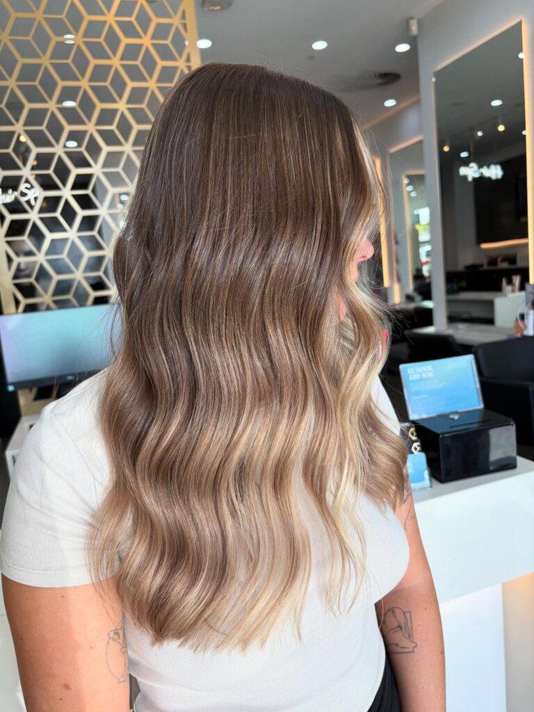 Hazel Bronde hair with a brunette base and blended beige-blonde highlights