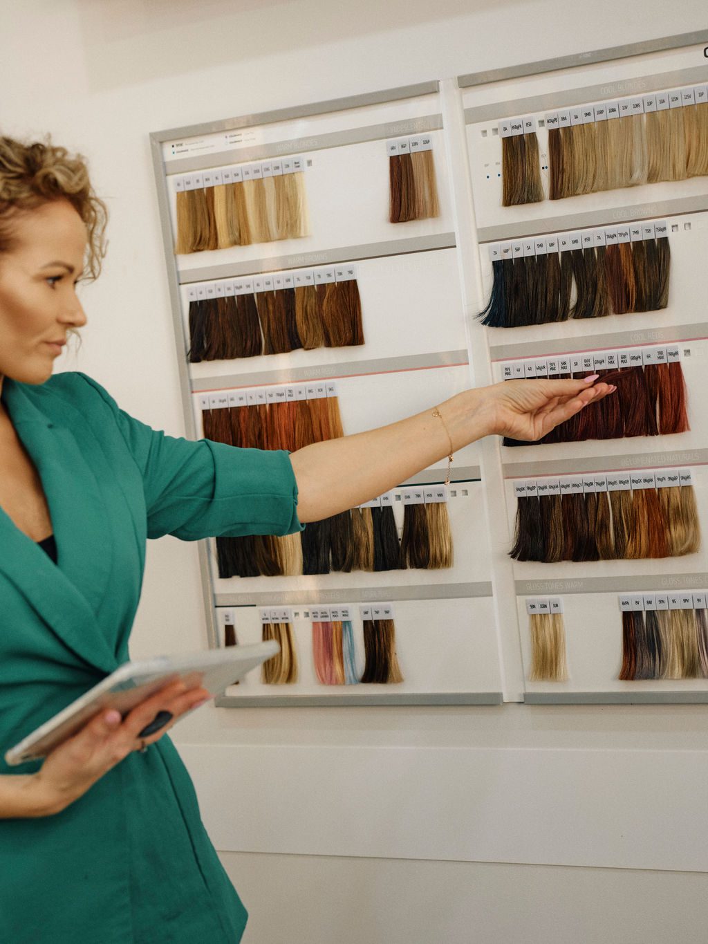 Epic Hair Designs colourist reviewing professional hair colour shades during a balayage consultation
