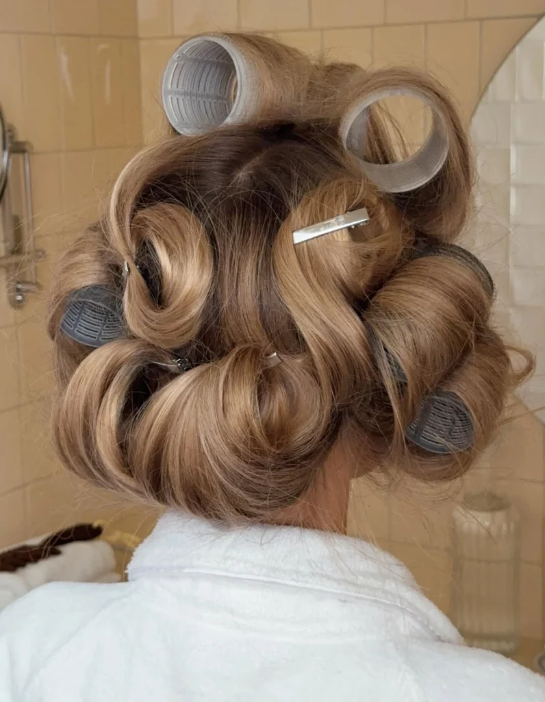blonde hair in rollers for heatless curls