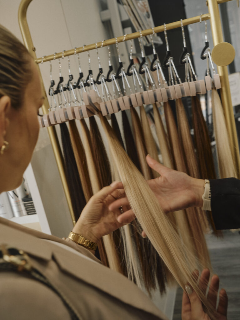 Epic stylist and client selecting a Showpony tape extension shade in salon