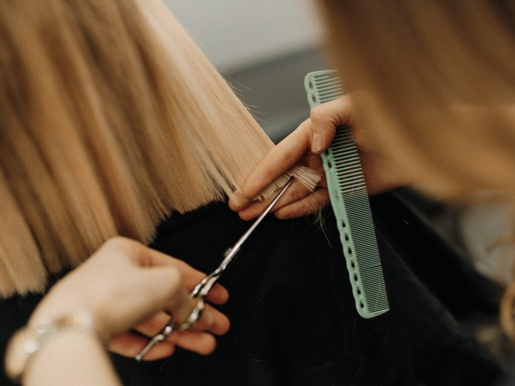 Epic stylist cutting the perimeter of a blonde bob