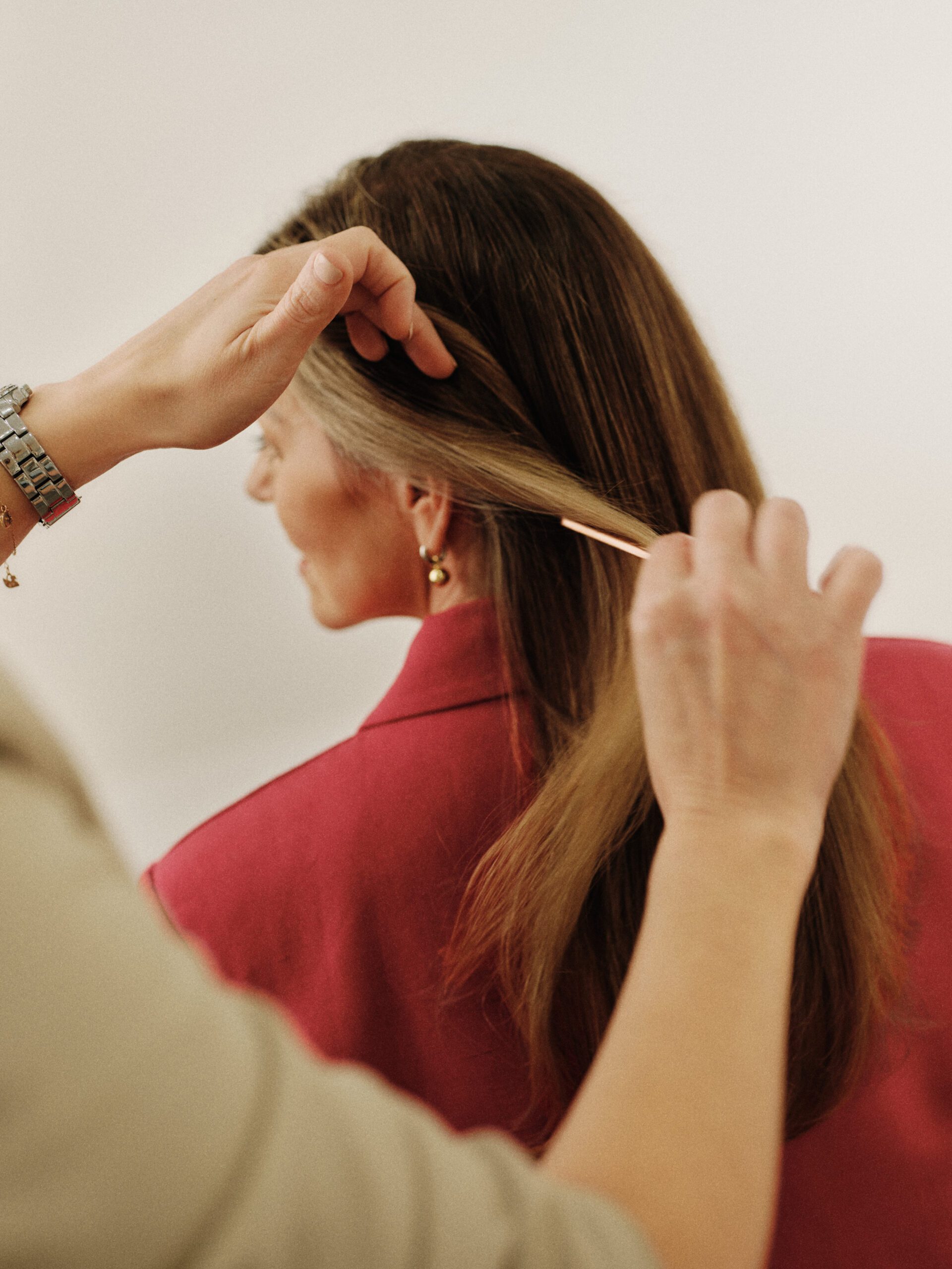 Caramel-highlighted hair being carefully sectioned during an Epic Hair Designs appointment