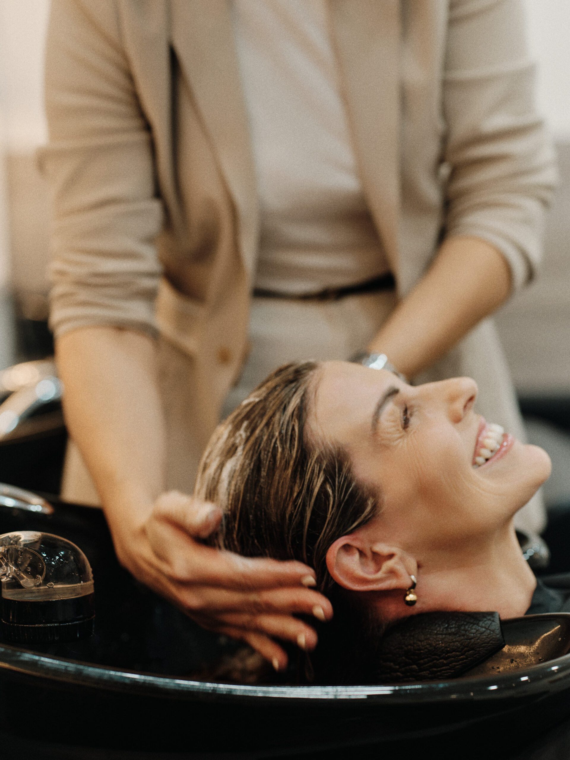 Epic Hair Designs client relaxing at the salon basin before a Goldwell Colour Lock treatment