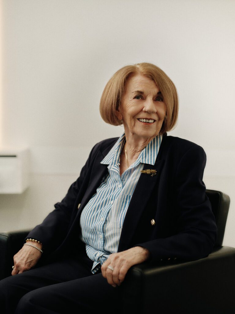 Epic client with a polished auburn bob seated in the salon